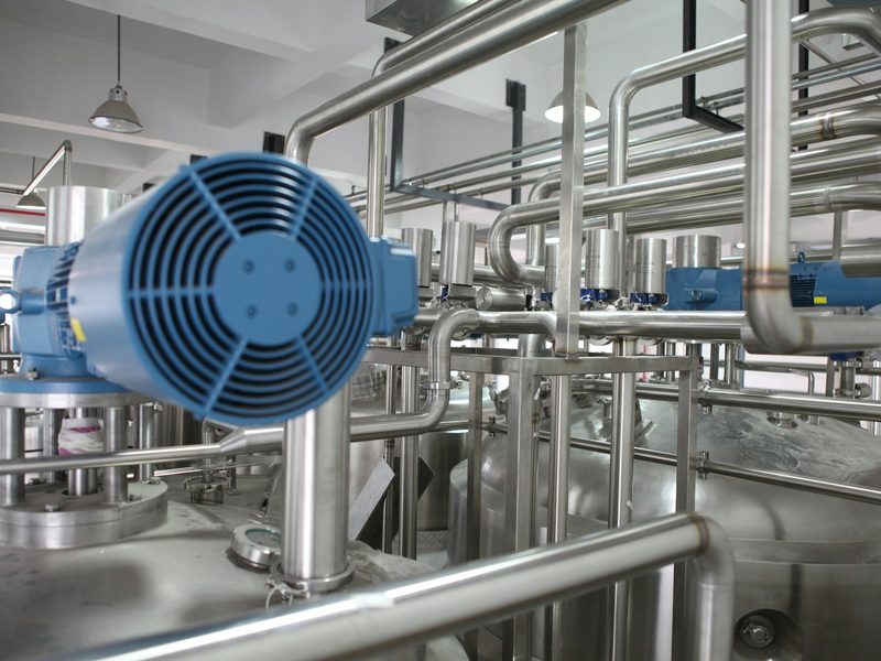Industrial Equipment Sourcing Company — Valves, Pipe, OCTG, MRO Supplies Industrial pump with motor on stainless steel piping